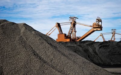 Manganese ore in stockpile at harbor loading site in Port Hedland, Pilbara, Western Australia.cReclaimer and stacker